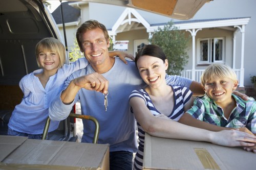 Professional movers unloading boxes at a new home
